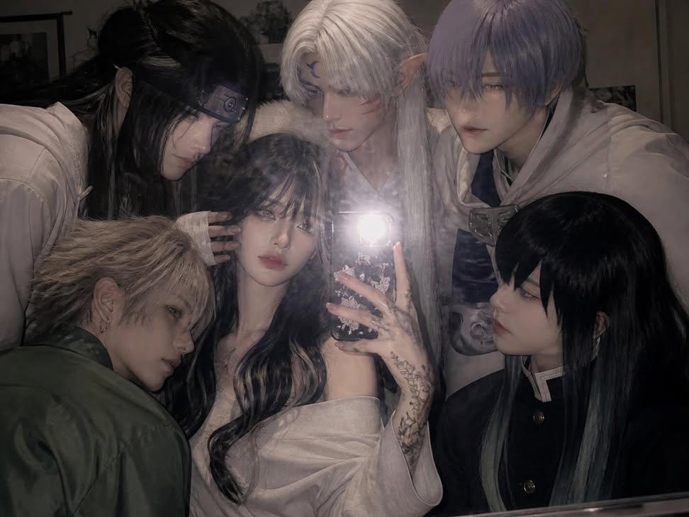 Holding a phone with the flash on, taking a mirror selfie in