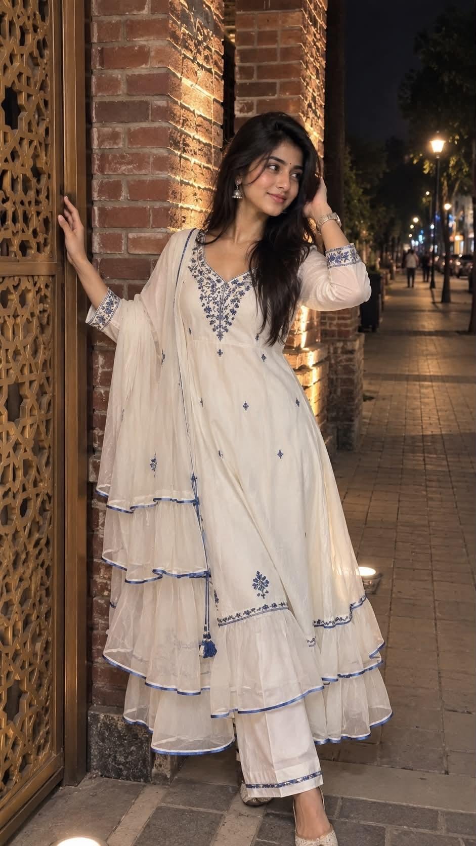 Create an image shows a young woman posing outdoors at night