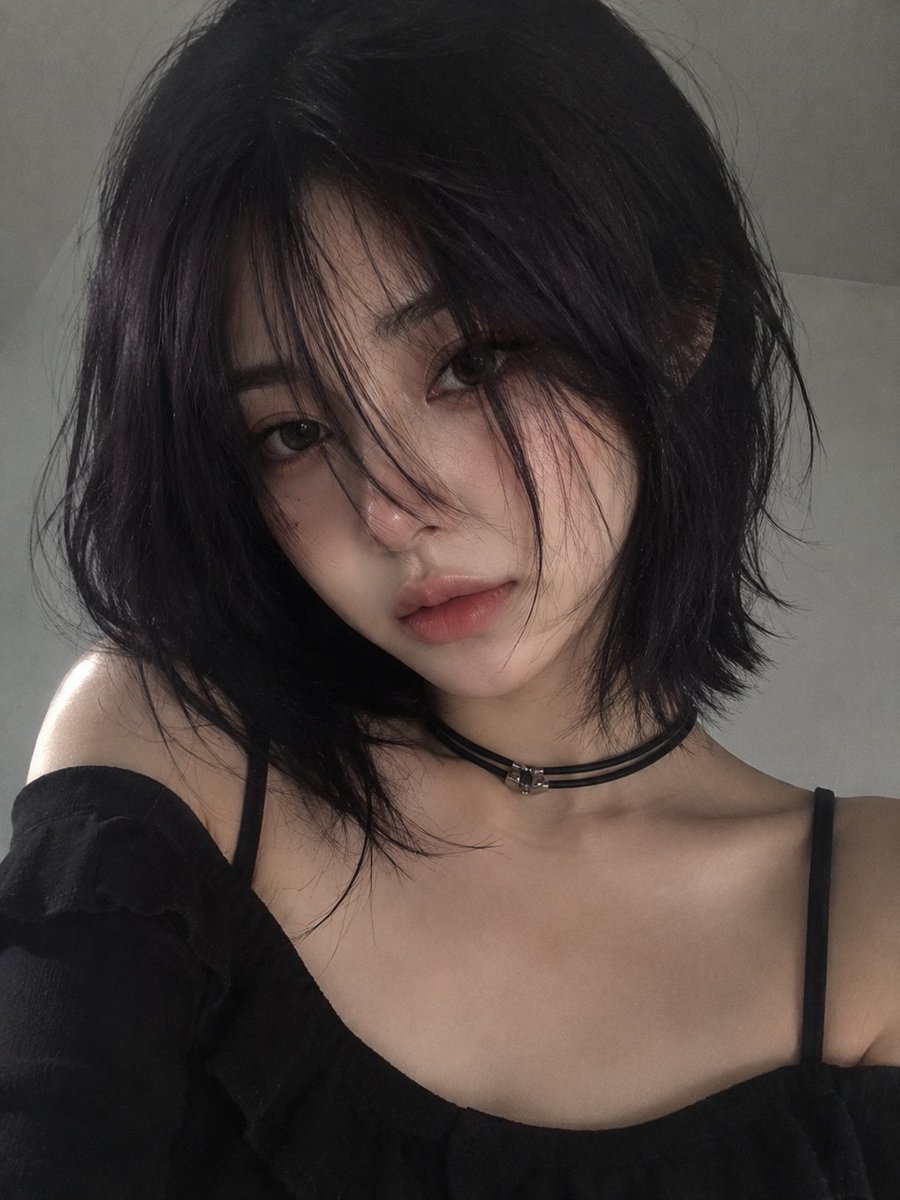 A soft minimalist portrait of a young woman with sleek dark