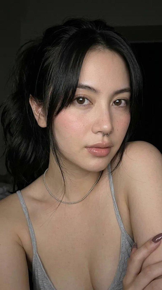 A high-end fashion studio portrait of a young woman with fai