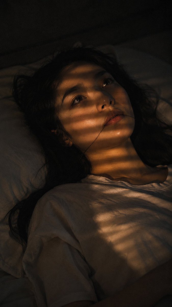 Close-up portrait, 85mm f/1.2, a young East Asian woman in h
