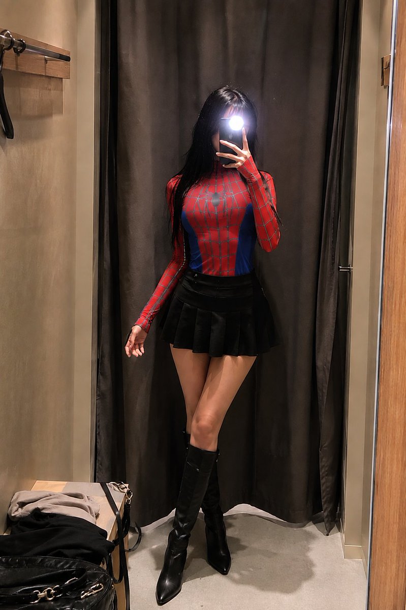1- A slim young woman taking a mirror selfie in a fitting ro
