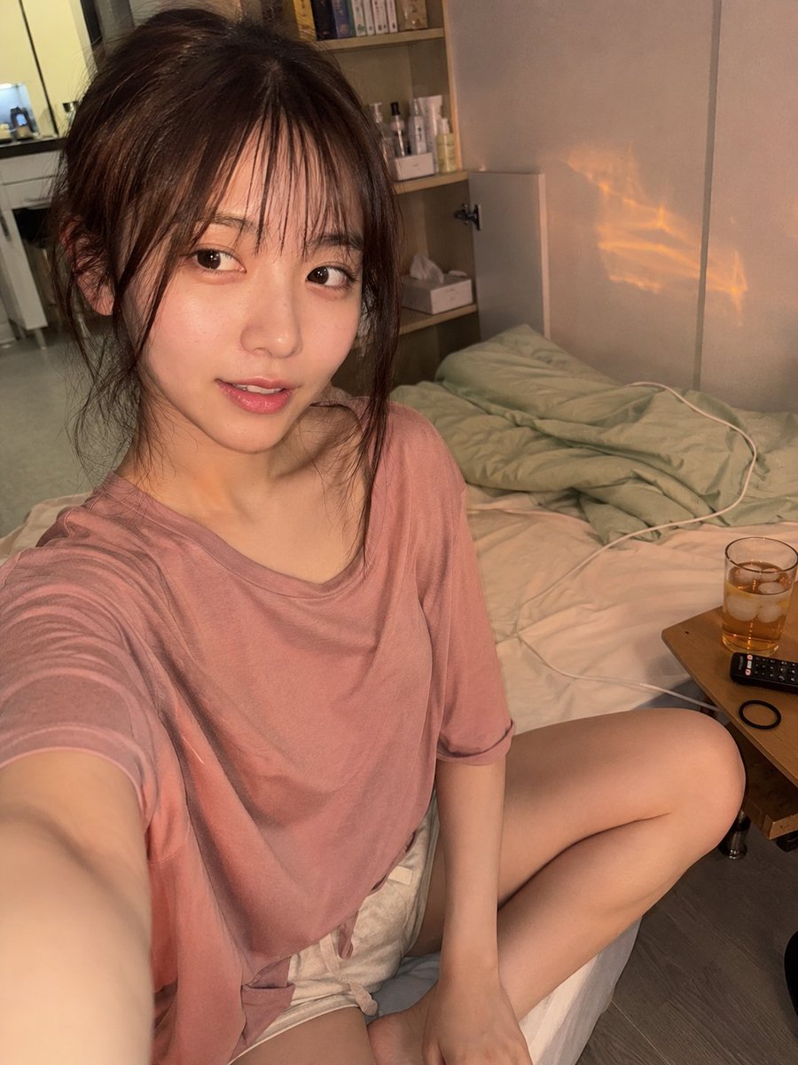 A photorealistic natural iPhone front-camera selfie of a com