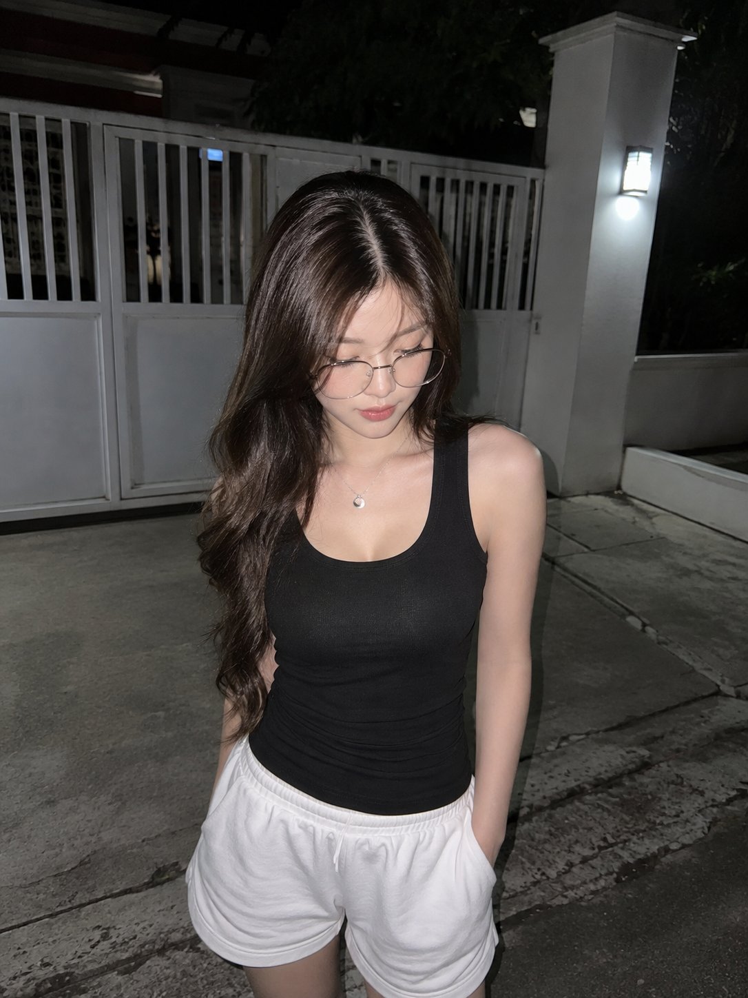 A realistic direct-flash candid night photo of a young East